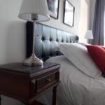 Beautiful bed of suite Fire with its old bedside table, its vintage bedside lamps and its fluffy pillows