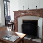 Private cosy lounge of suite Fire with nice marble fireplace, armchairs and coffee table to read a magazine