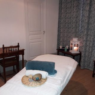 Massage table in the lounge of the suite Water with pretty soothing decoration in shades of blue