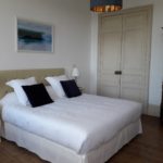 Beautiful and spacious guest room Water with high-quality king size bed, soft pillows and water-themed photo frame