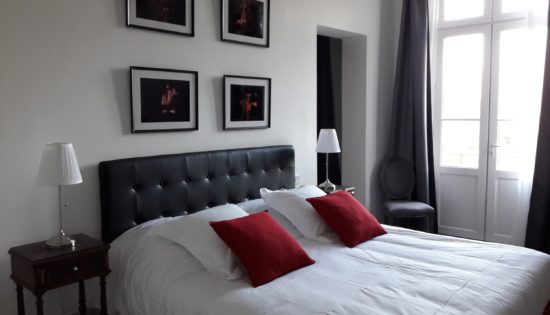 Beautiful guestroom with very comfortable king size bed, fluffy pillows and cushions and fire pictures