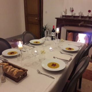 Elegantly dressed dinner table by the fireplace