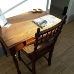 Desk area in the lounge with pretty old chair and magazine