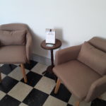 Cosy lounge area with two armchairs and side table to relax